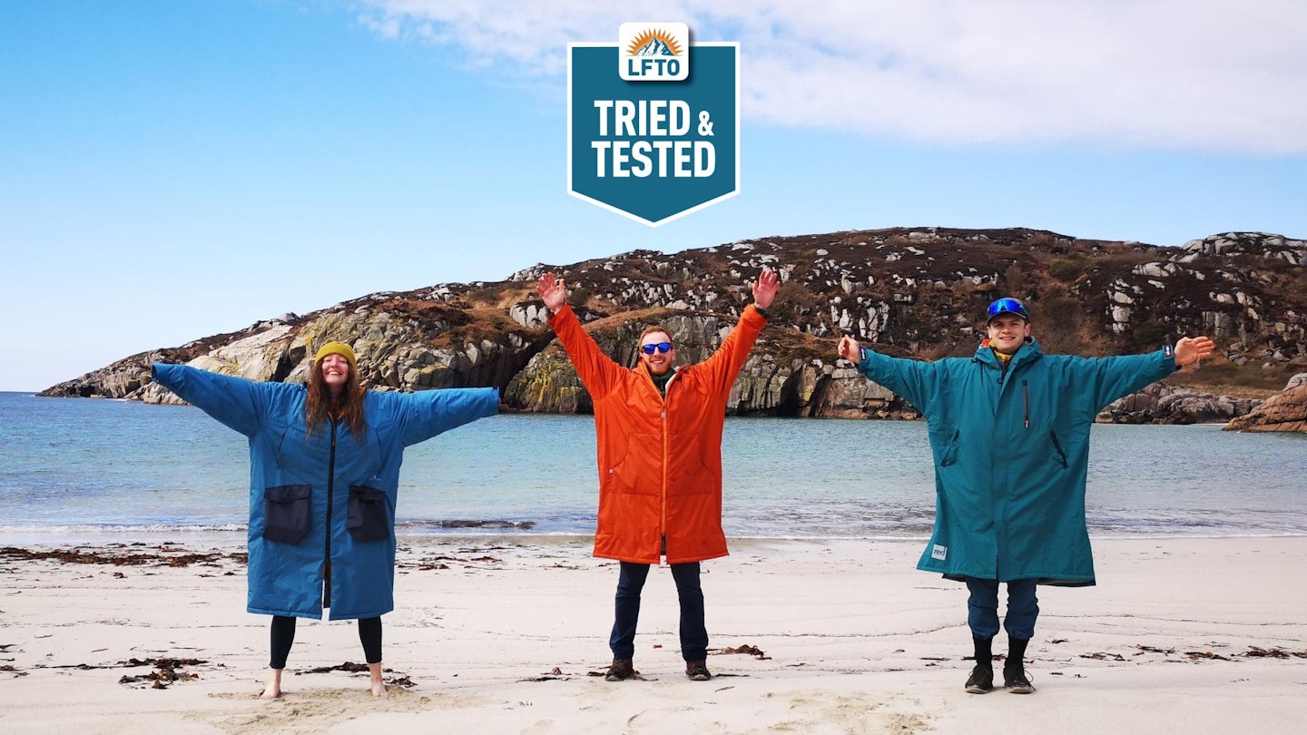 Three people on the beach wearing the best changing robes