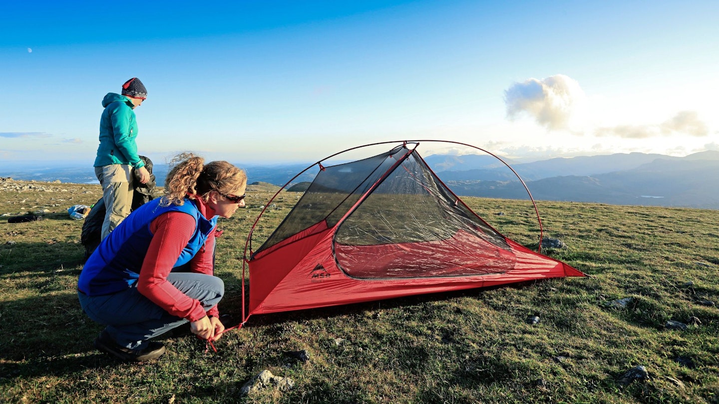 Hiker breaking camp in the morning